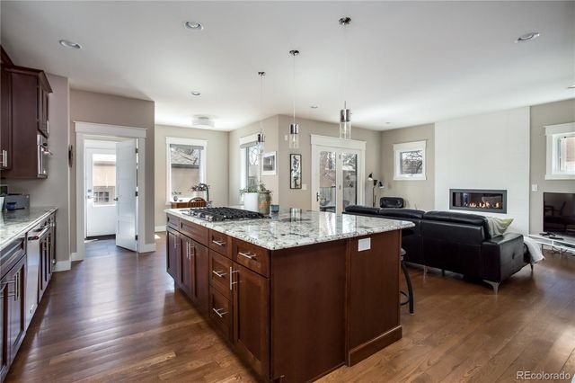 a kitchen with counter top space and wooden floor