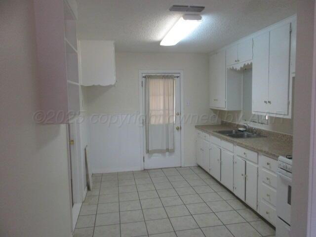 4109 South Bowie Street Amarillo, TX 79110 - Photo 12 of 13 a view of a kitchen with white cabinets