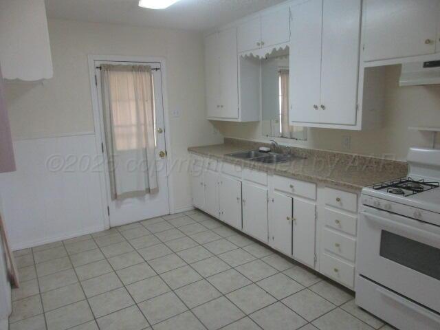 4109 South Bowie Street Amarillo, TX 79110 - Photo 13 of 13 a kitchen with a sink stove and cabinets