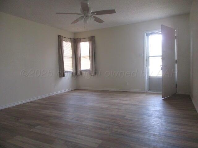 4109 South Bowie Street Amarillo, TX 79110 - Photo 4 of 13 an empty room with wooden floor and windows