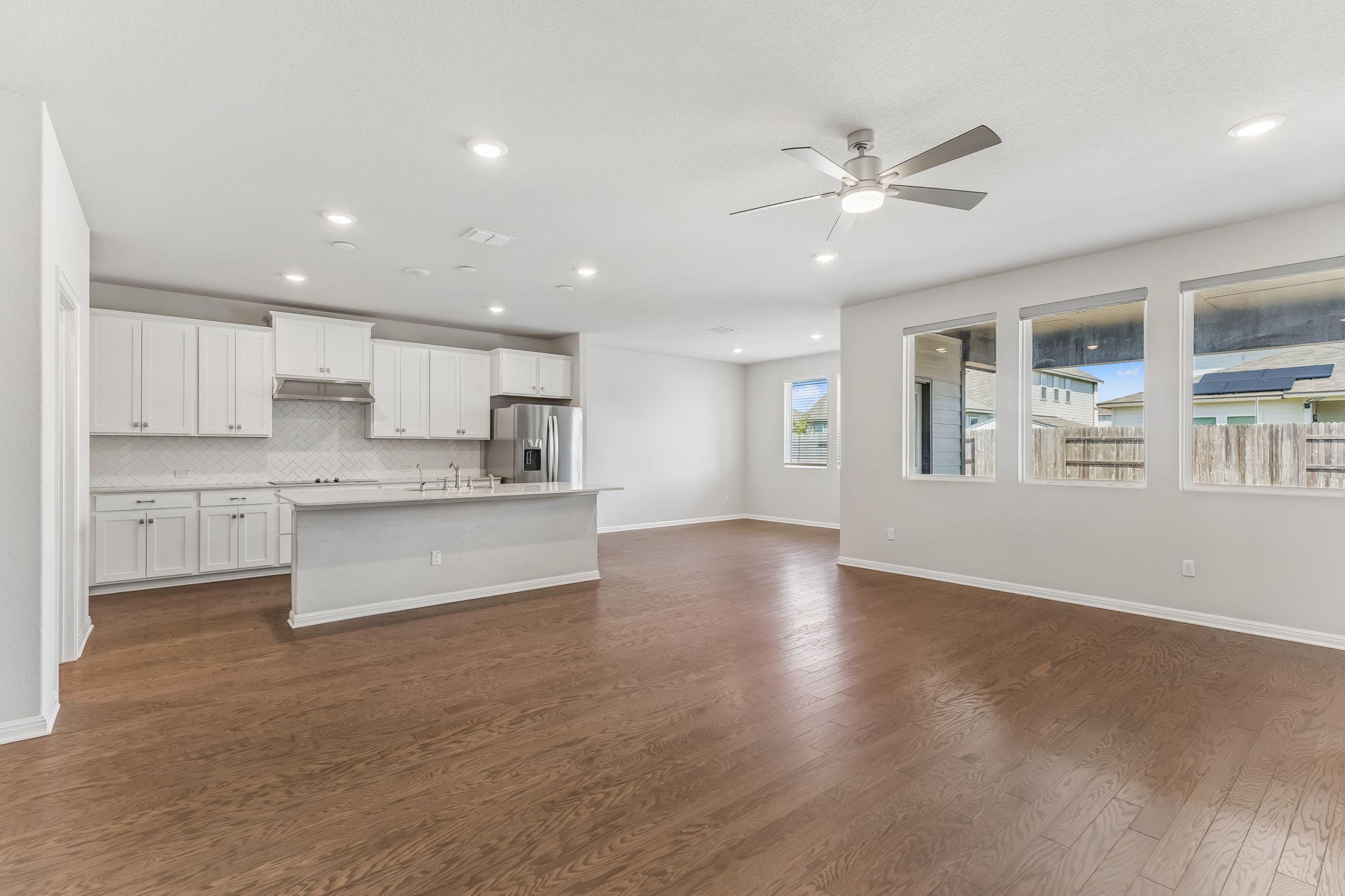 Gleaming hardwood floors and a modern kitchen anchors this open concept living space.