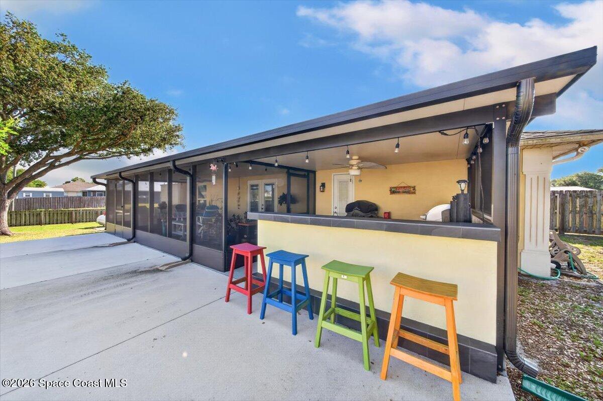 5975 Aruin Street Cocoa, FL 32927 - Photo 5 of 70 a view of a patio with a table and chairs