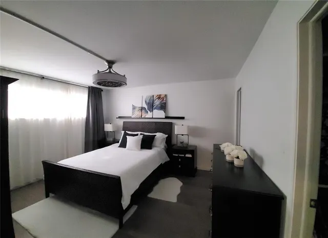 a bedroom with a bed and window