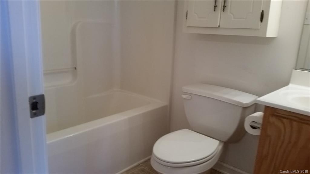 2032 Cansler Road Vale, NC 28168 - Photo 10 of 15 a white toilet sitting next to a bath tub