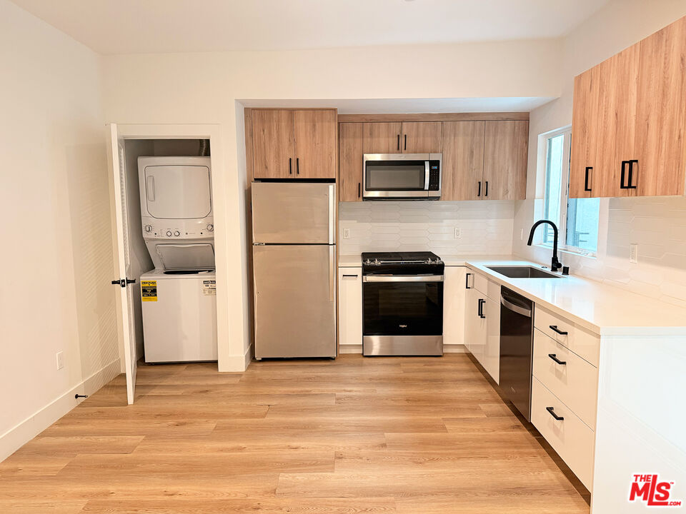 914 7th Street, Unit 9 Santa Monica, CA 90403 - Photo 1 of 9 a kitchen with white cabinets and white appliances