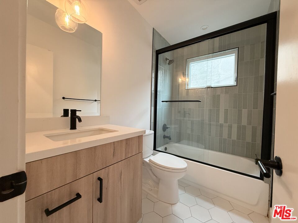 914 7th Street, Unit 9 Santa Monica, CA 90403 - Photo 4 of 9 a bathroom with a sink a toilet and shower