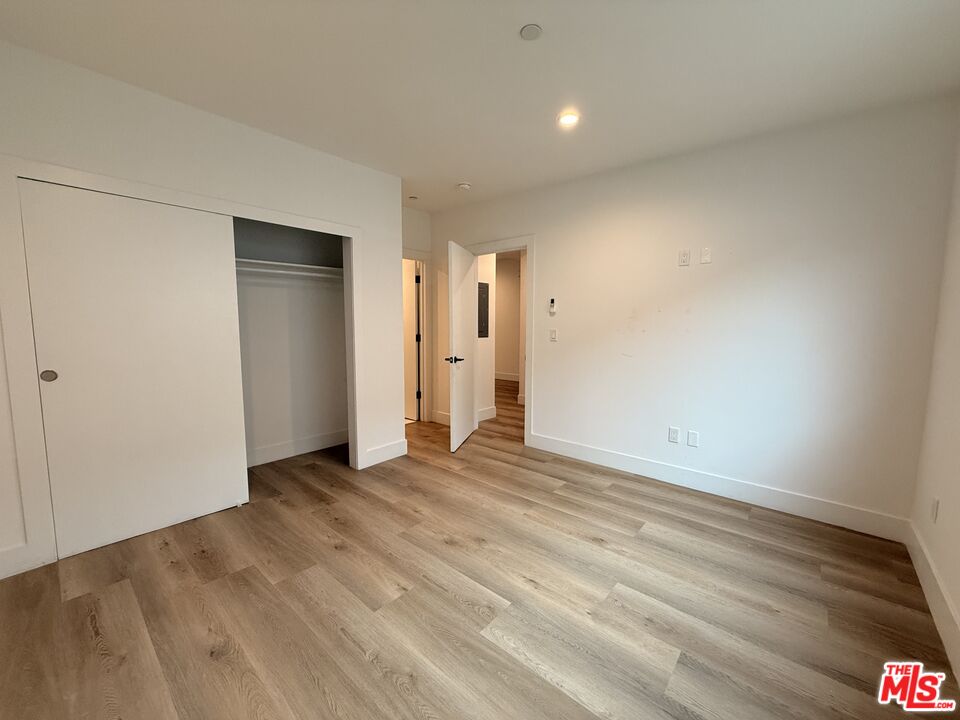 914 7th Street, Unit 9 Santa Monica, CA 90403 - Photo 6 of 9 a view of an empty room with wooden floor and closet