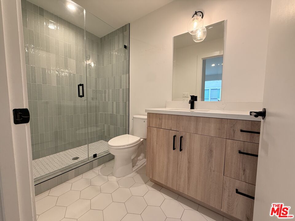 914 7th Street, Unit 9 Santa Monica, CA 90403 - Photo 8 of 9 a bathroom with a sink a toilet and shower