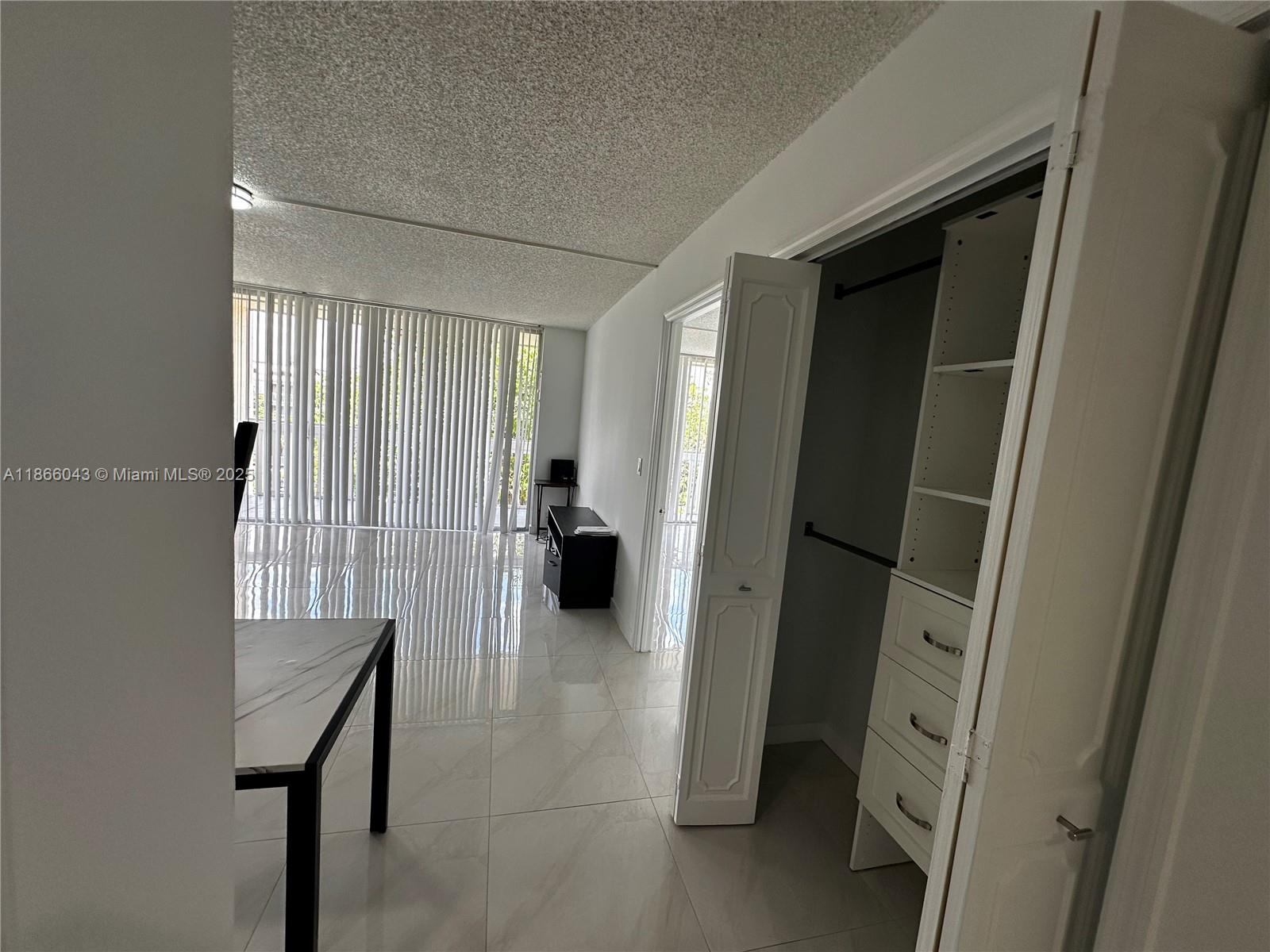 7051 Environ Boulevard, Unit 431 Lauderhill, FL 33319 - Photo 15 of 35 a view of a hallway with furniture and a window