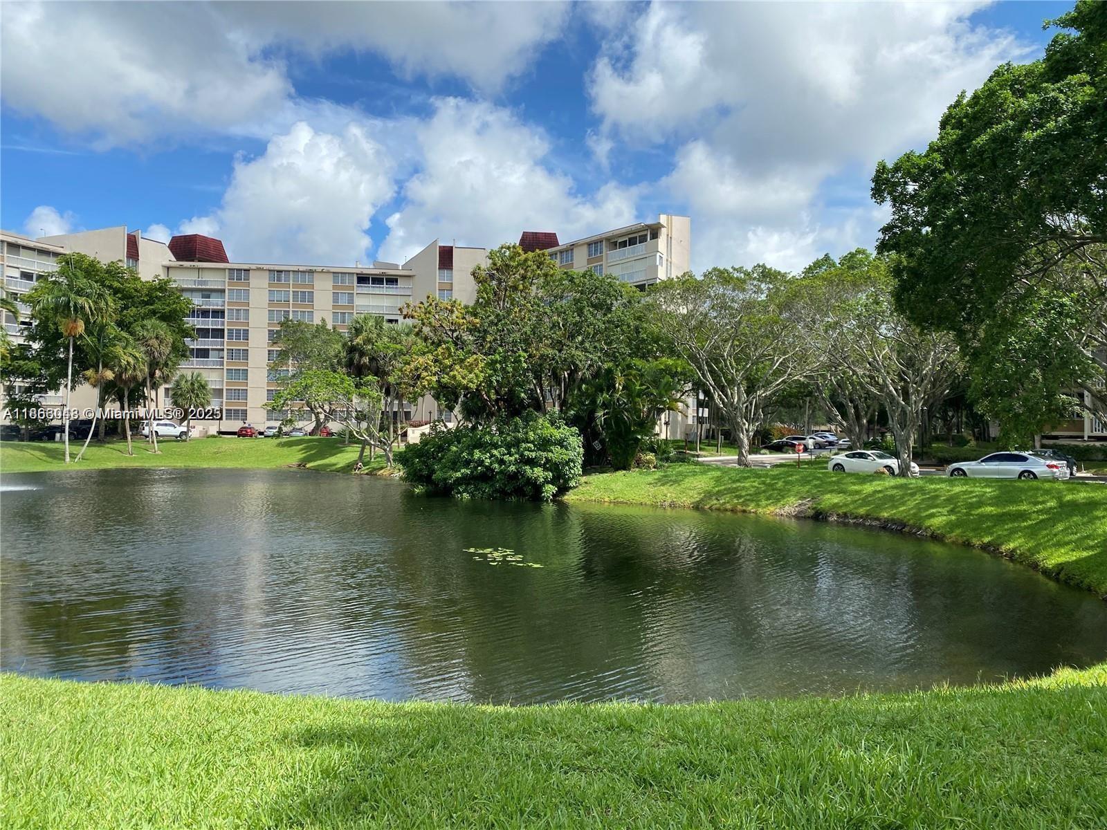 7051 Environ Boulevard, Unit 431 Lauderhill, FL 33319 - Photo 2 of 35 a view of a lake with a building in the background