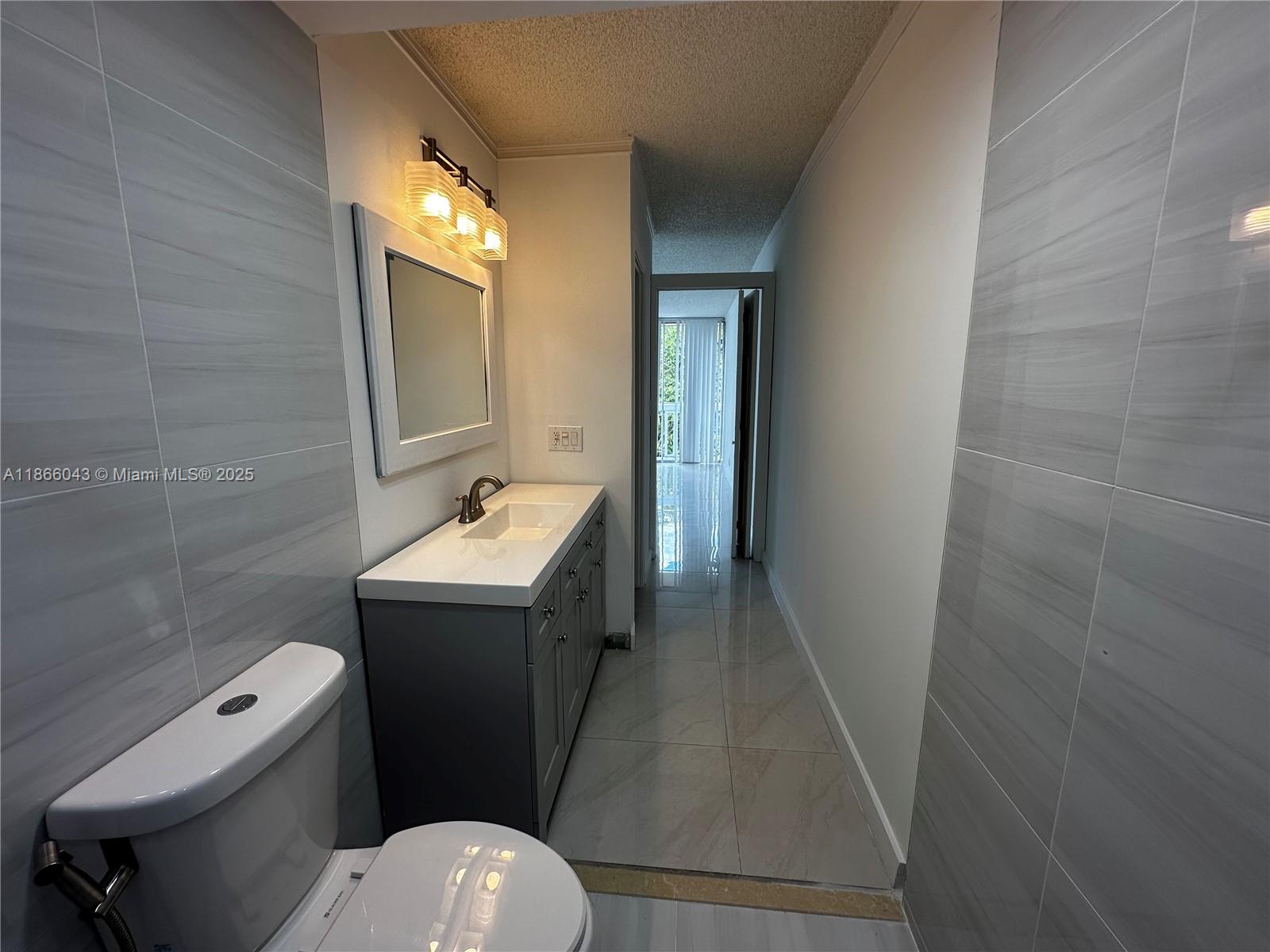 7051 Environ Boulevard, Unit 431 Lauderhill, FL 33319 - Photo 24 of 35 a bathroom with a sink a toilet and shower