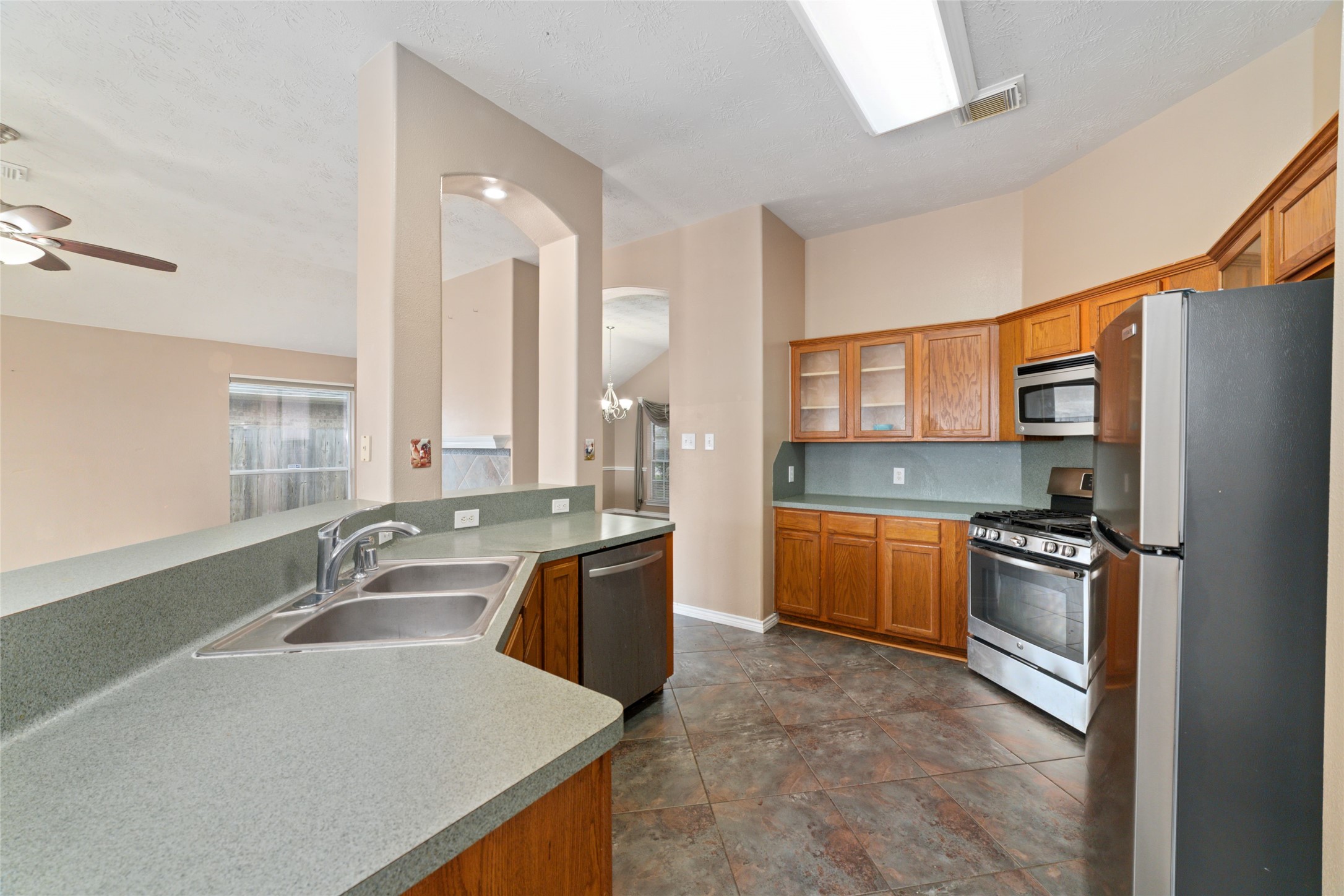 22911 Sebastian Drive Porter, TX 77365 - Photo 11 of 23 a kitchen with a sink stove and refrigerator