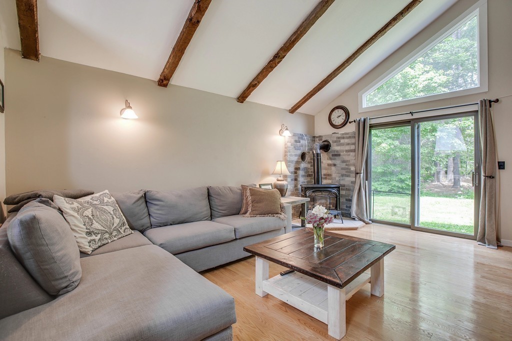 43 Laurel Road Bolton, MA 01740 - Photo 2 of 28 a living room with furniture and large windows