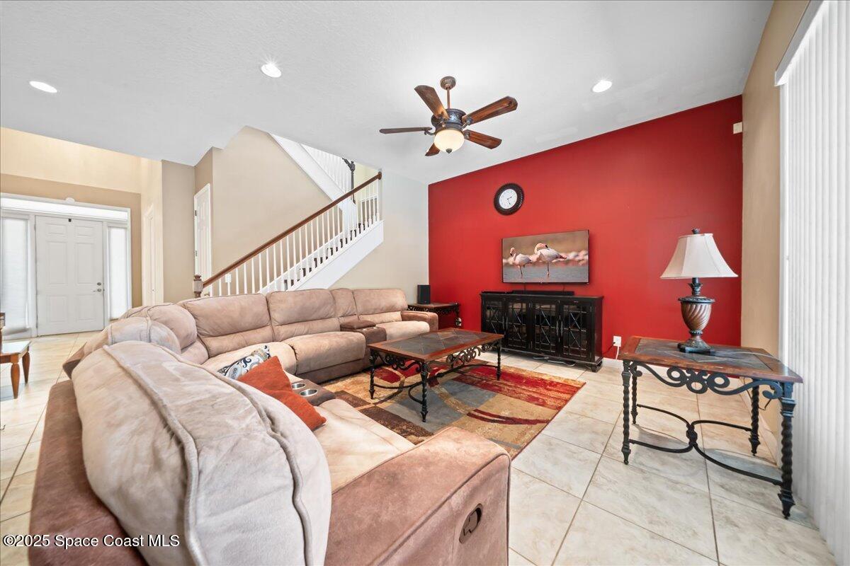 1777 Sienna Drive Melbourne, FL 32934 - Photo 11 of 31 a living room with furniture a rug and a chandelier