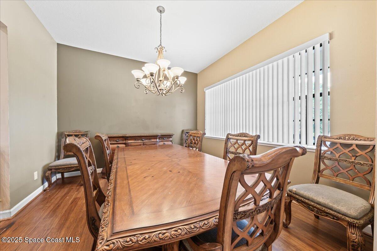 1777 Sienna Drive Melbourne, FL 32934 - Photo 12 of 31 a view of a dining room with furniture and a chandelier