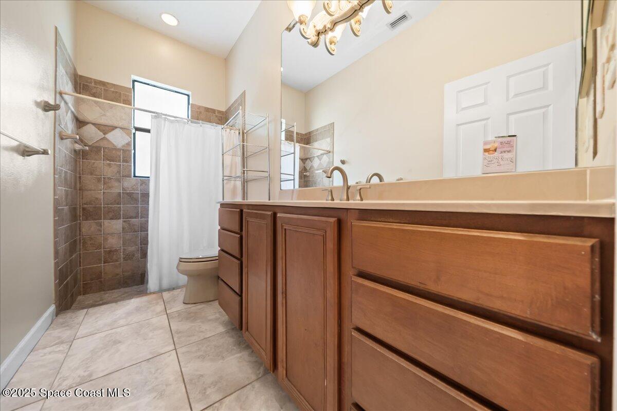 1777 Sienna Drive Melbourne, FL 32934 - Photo 20 of 31 a bathroom with a sink a toilet and shower