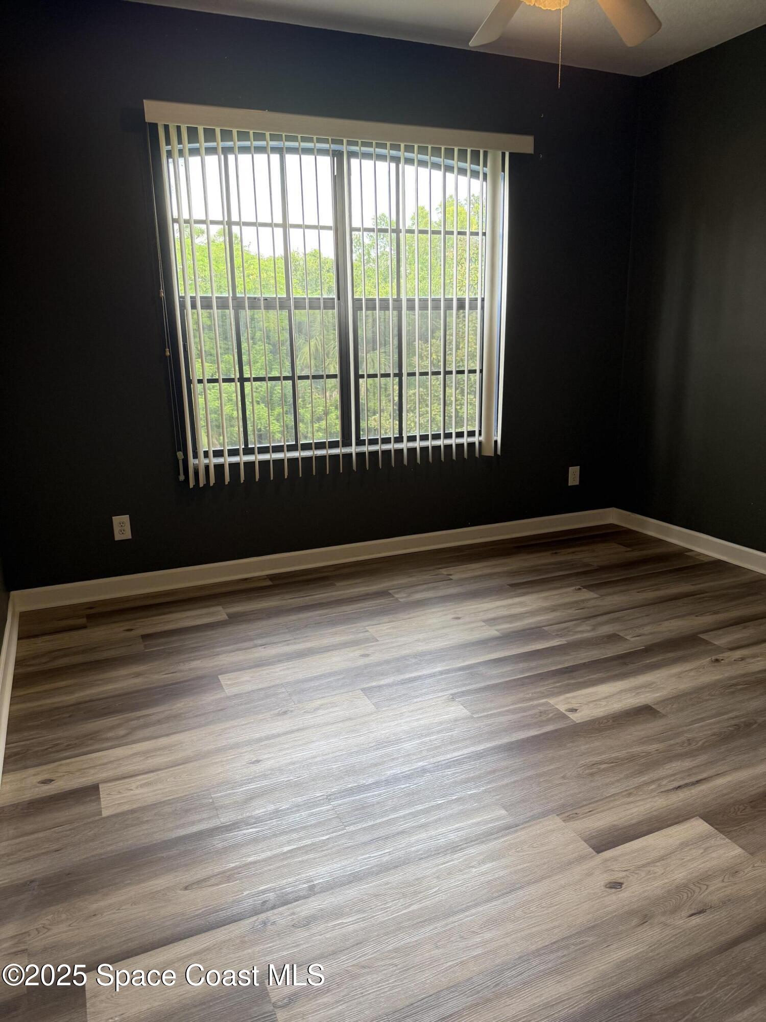 1777 Sienna Drive Melbourne, FL 32934 - Photo 22 of 31 a view of wooden floor and windows in a room