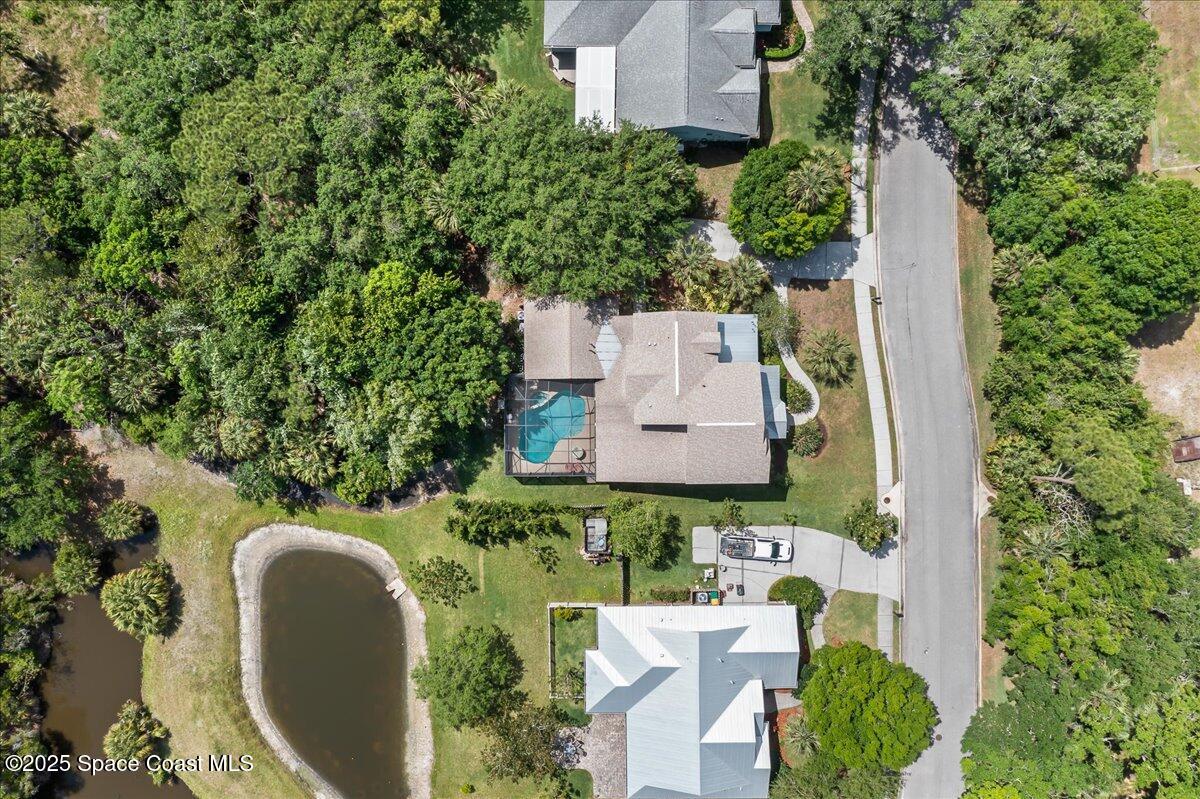 1777 Sienna Drive Melbourne, FL 32934 - Photo 25 of 31 an aerial view of a house with a yard and trees