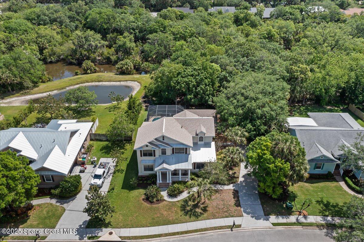 1777 Sienna Drive Melbourne, FL 32934 - Photo 28 of 31 an aerial view of a house with a yard garage and lake view