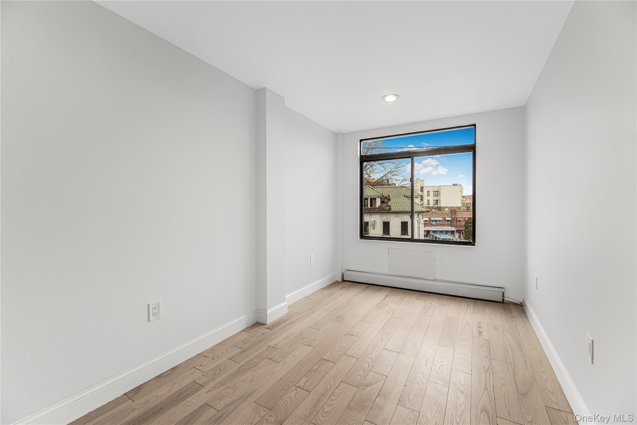 3067 Williamsbridge Road Bronx, NY 10467 - Photo 11 of 29 a view of an empty room with wooden floor and a window