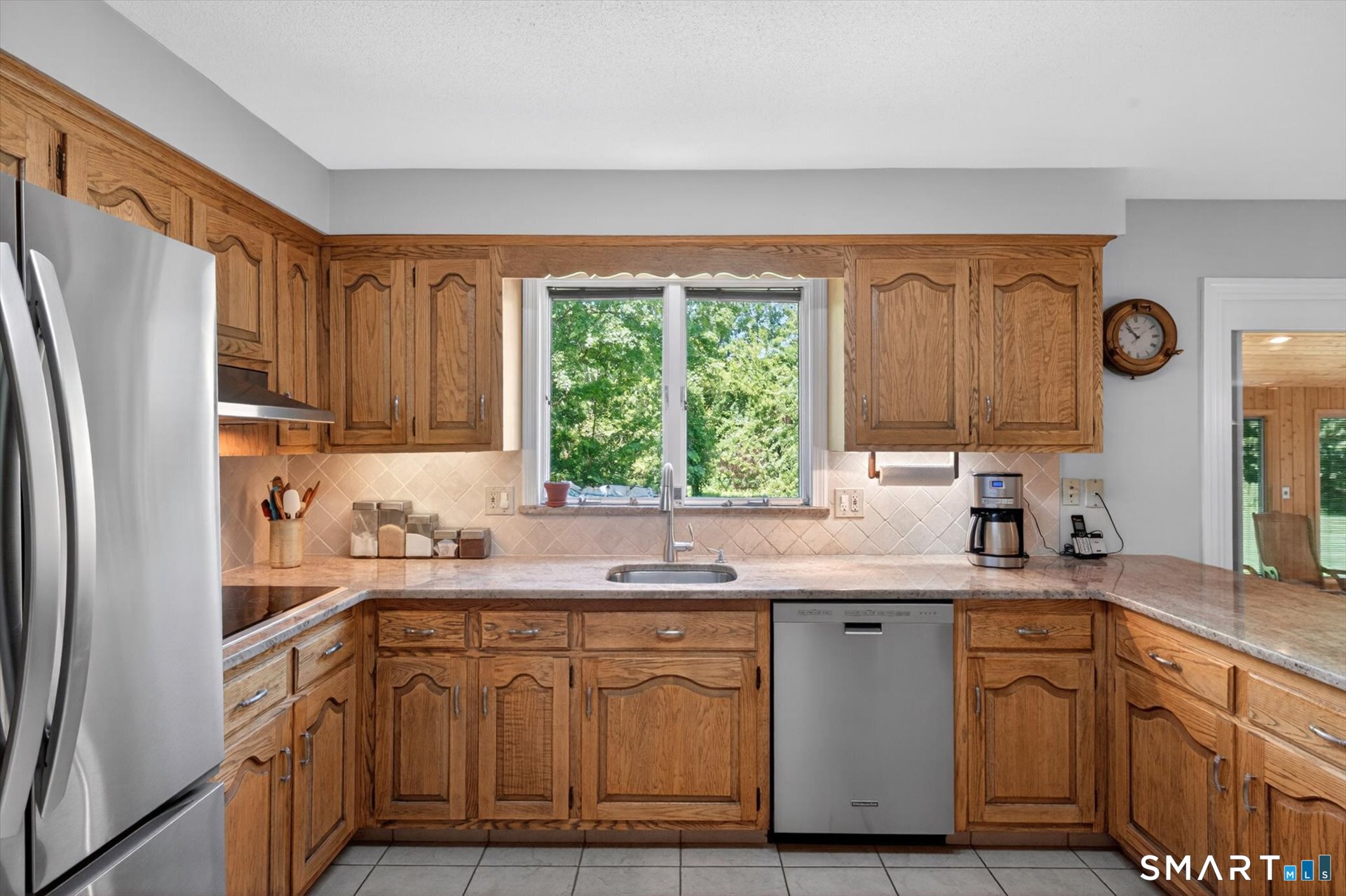 5 Shingle Mill Drive Canton, CT 06019 - Photo 11 of 38 a kitchen with stainless steel appliances granite countertop a sink a stove a refrigerator with grey cabinets and wooden floor
