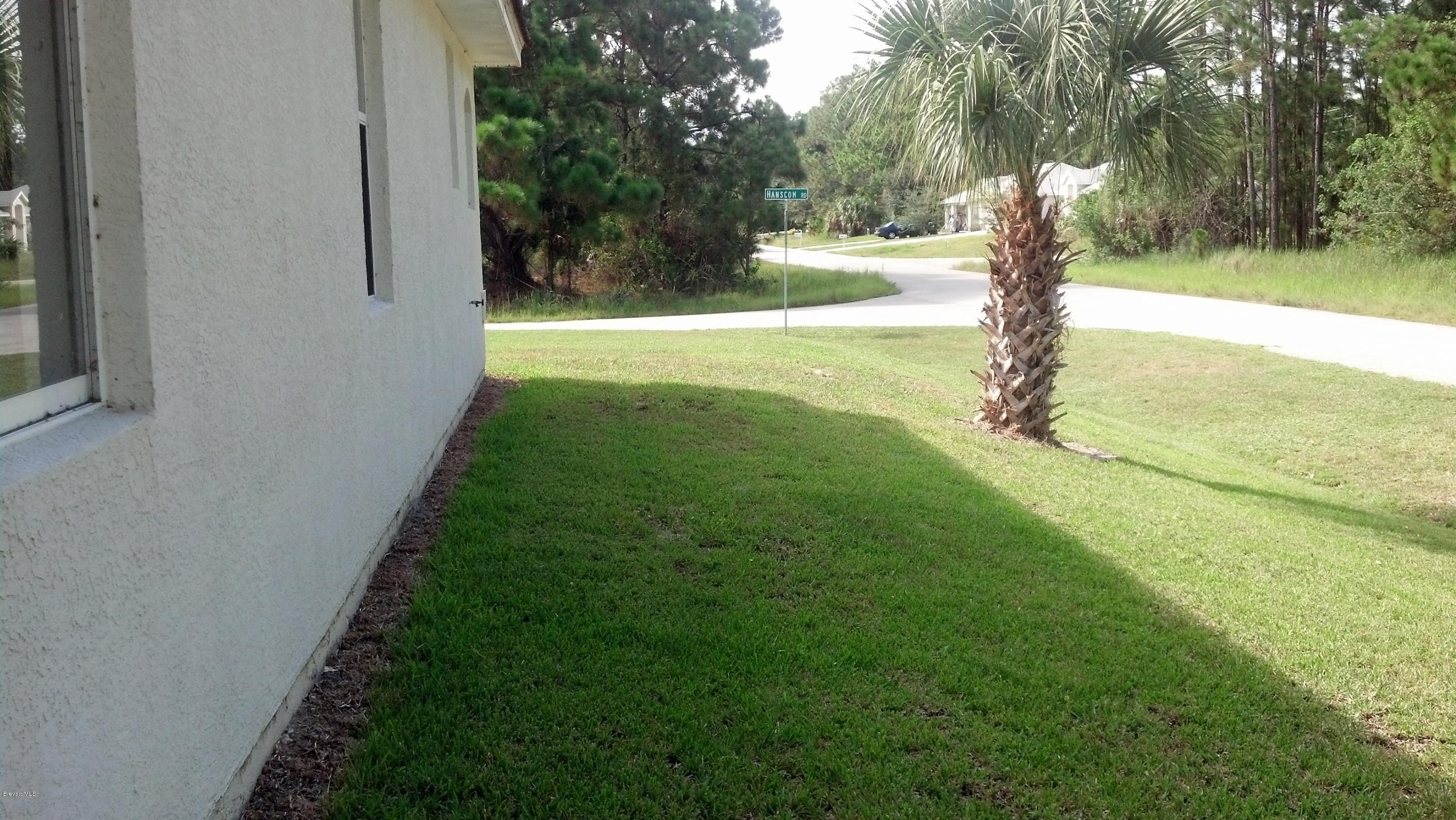 1401 Hanscom Road Southwest Palm Bay, FL 32908 - Photo 2 of 12 HANSCOM SIDE YARD