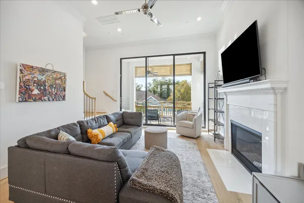 a living room with furniture a fireplace and a flat screen tv