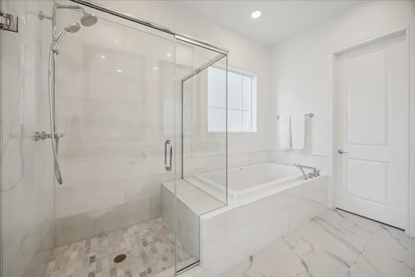 a bathroom with a bathtub and a shower