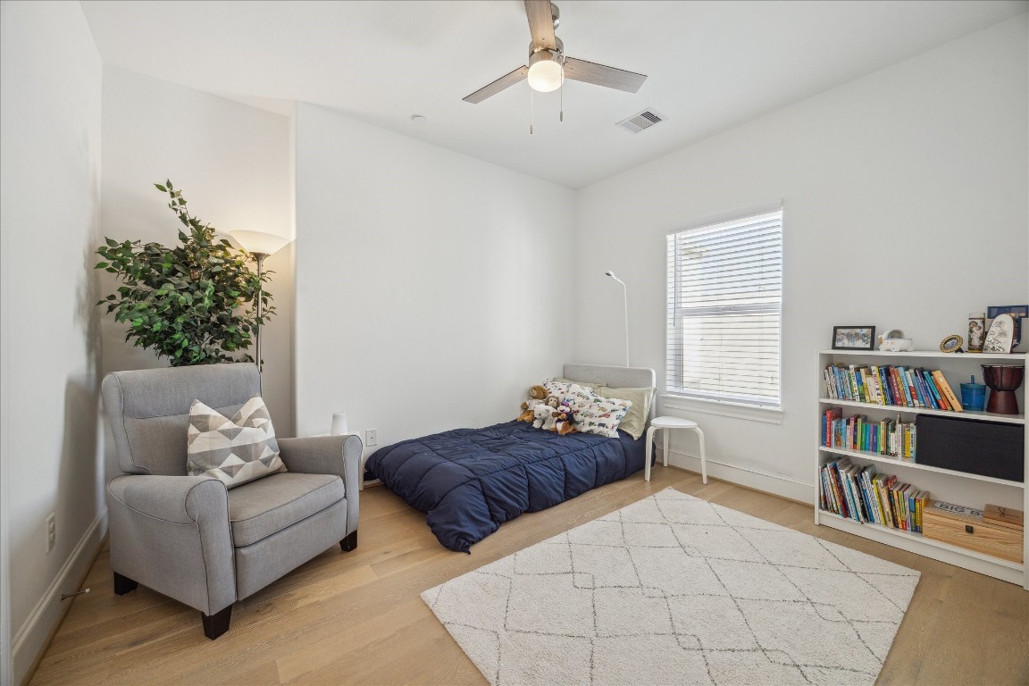 2714 Harvard Street Houston, TX 77008 - Photo 25 of 32 a living room with a bed and a book shelf