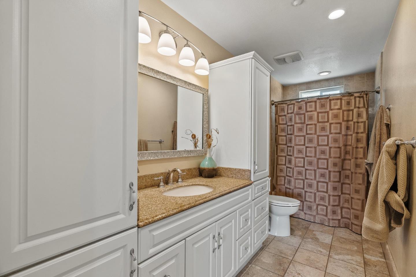 350 San Benancio Road Salinas, CA 93908 - Photo 22 of 68 a bathroom with a granite countertop sink a toilet and shower