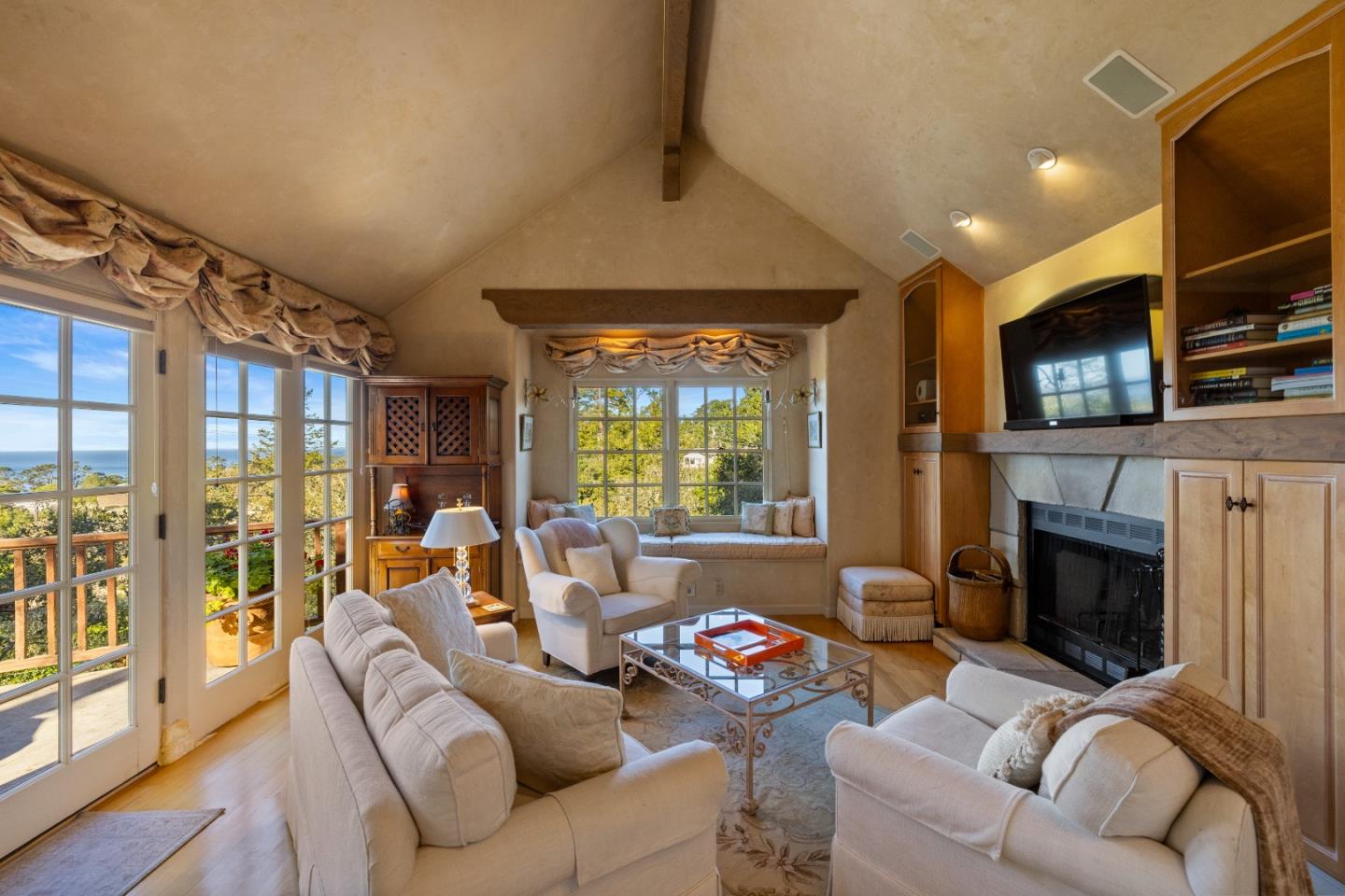 a living room with furniture fireplace and flat screen tv