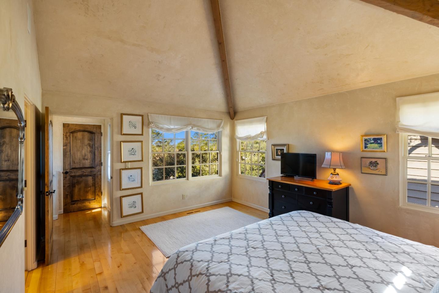 3 Santa Fe Street Carmel, CA 93923 - Photo 27 of 72 a bedroom with a bed and wooden floor