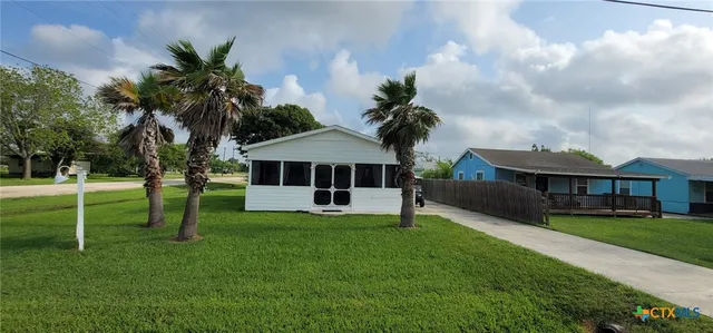 a view of a house with a big yard and potted plants