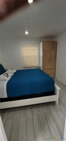 a view of room with window and wooden floor