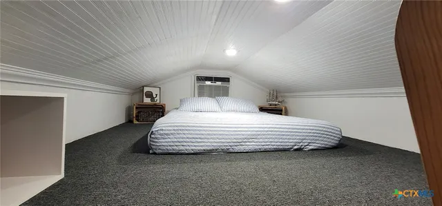 a bedroom with a bed and a night stand