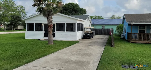 a front view of a house with a garden and yard