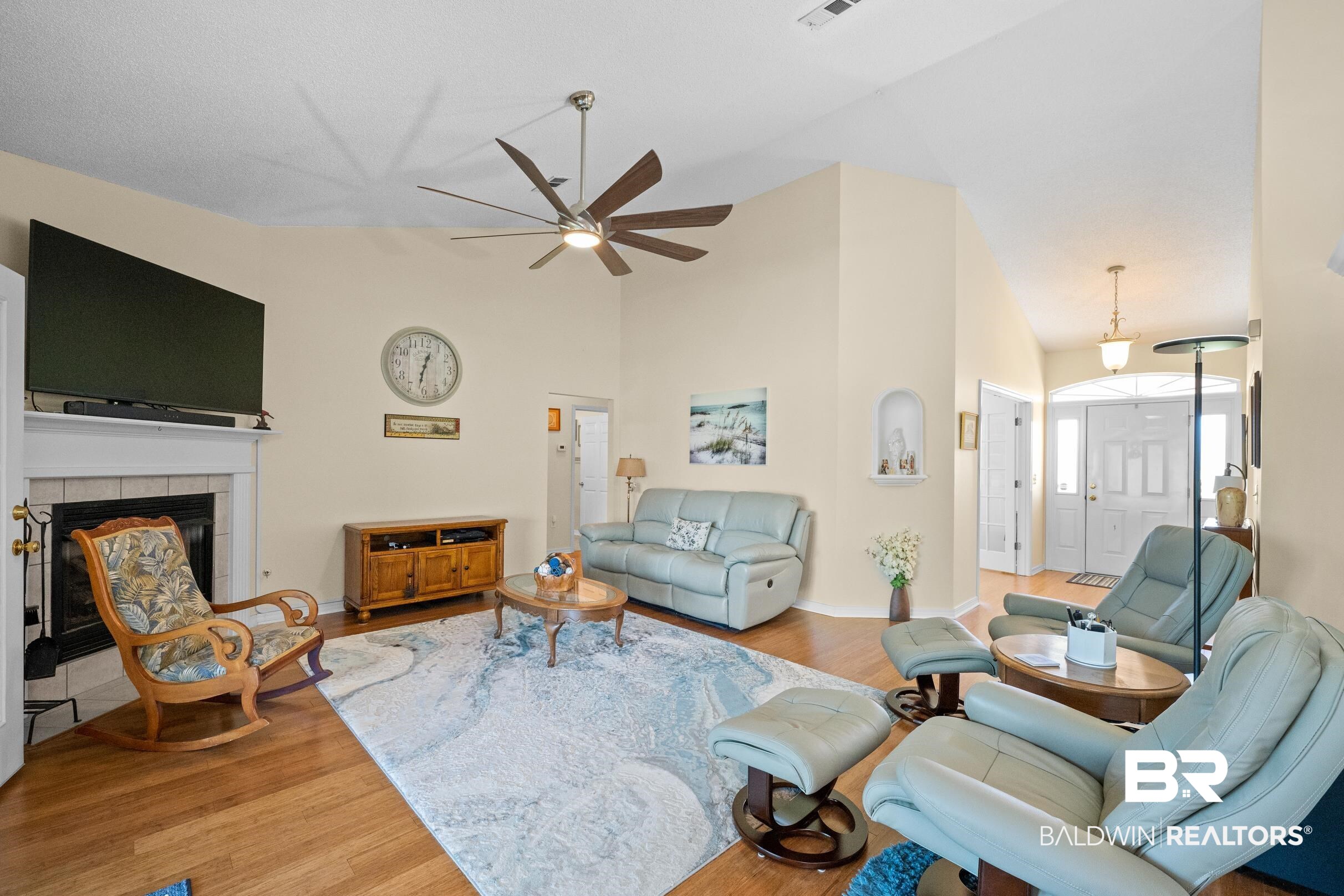22355 East County Road 12 Foley, AL 36535 - Photo 7 of 54 Living room with wood finished floors, high vaulted ceiling, a tiled fireplace, and a ceiling fan