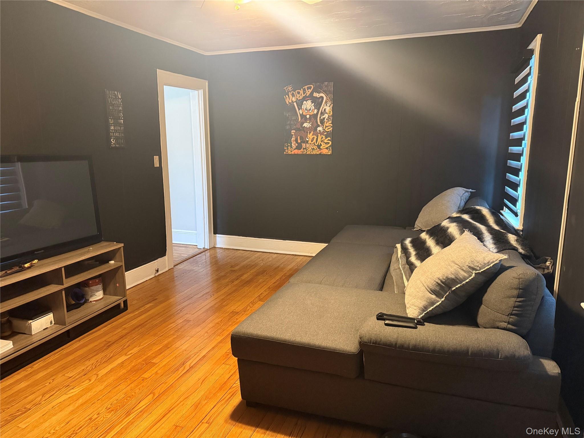 50 The Crescent, Unit B1 Babylon, NY 11702 - Photo 3 of 7 a bedroom with a bed and a couch