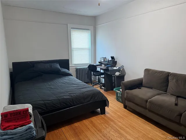 a bedroom with furniture and wooden floor