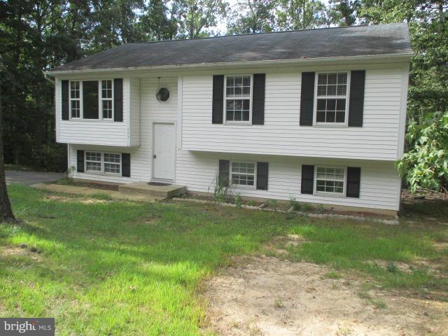 743 Lazy River Road Lusby, MD 20657 - Photo 1 of 16 a front view of a house with a garden