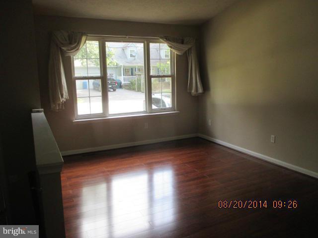 743 Lazy River Road Lusby, MD 20657 - Photo 2 of 16 a view of an empty room with wooden floor and a window