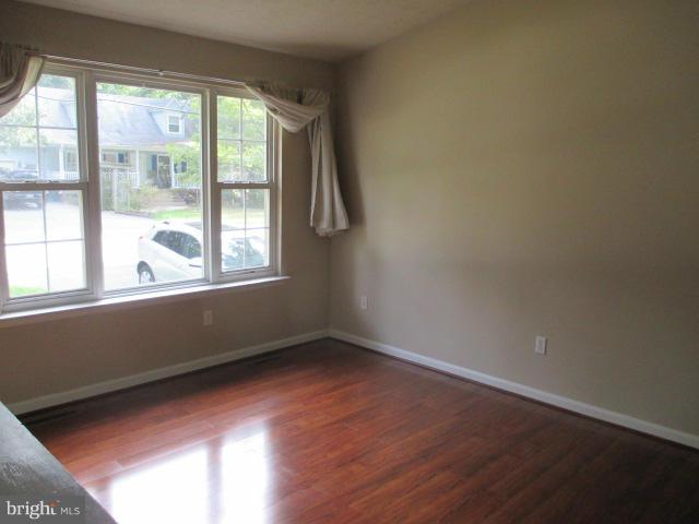 743 Lazy River Road Lusby, MD 20657 - Photo 11 of 16 a view of an empty room with wooden floor and a window