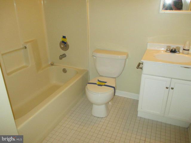 743 Lazy River Road Lusby, MD 20657 - Photo 10 of 16 a bathroom with a toilet sink and mirror
