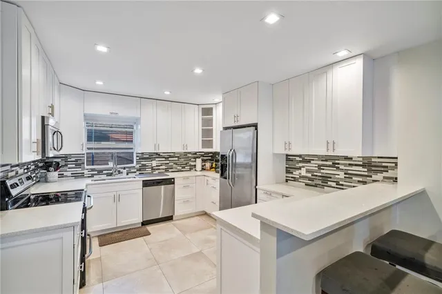 a kitchen with refrigerator and stove
