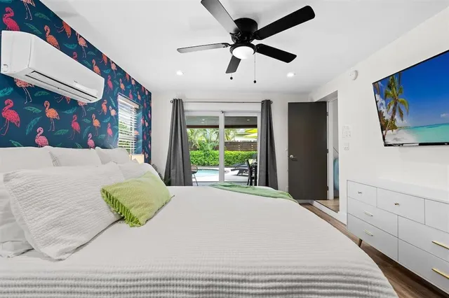 a bedroom with a large bed and a flat screen tv