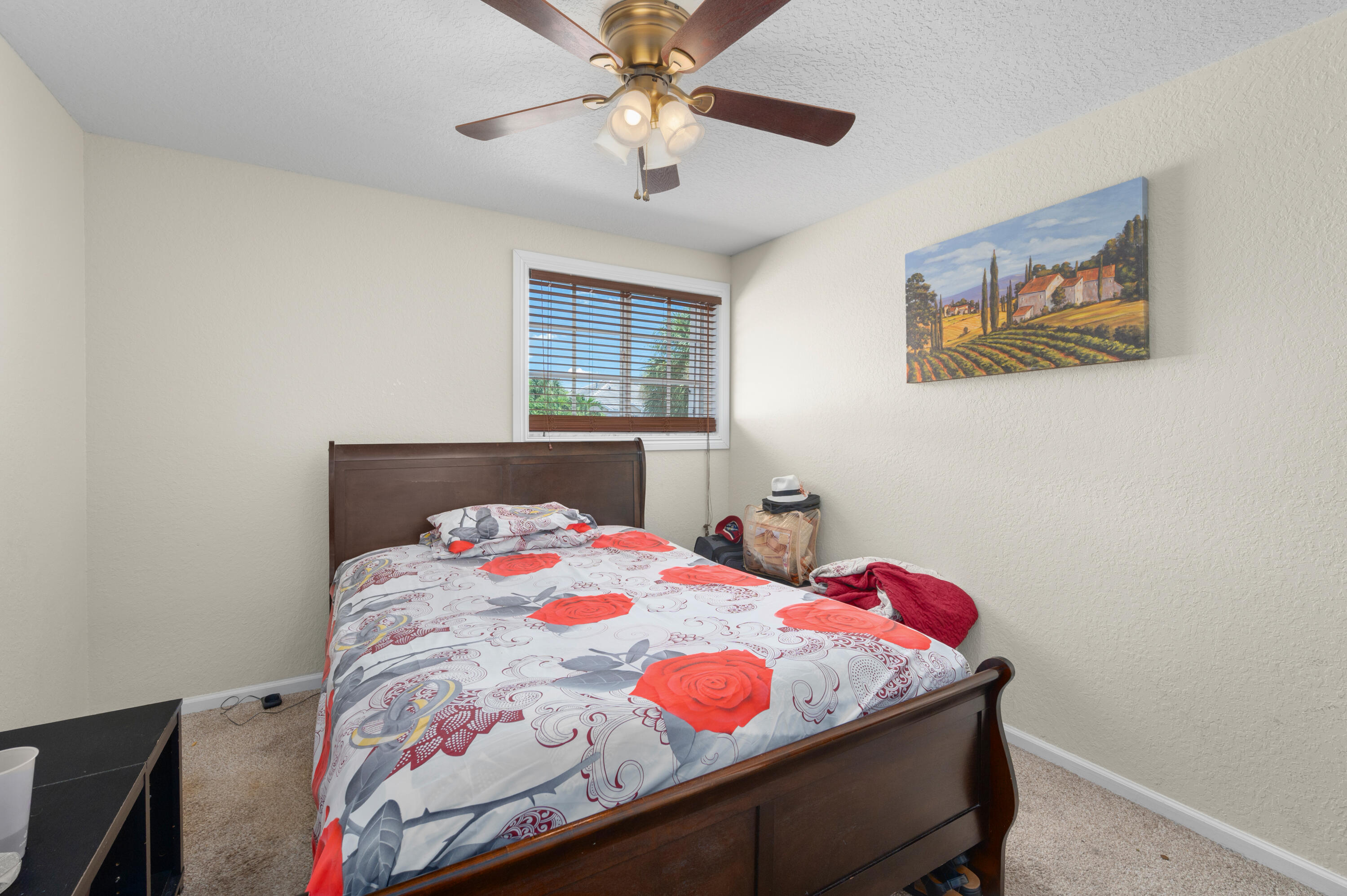 311 Berenger Walk Royal Palm Beach, FL 33414 - Photo 20 of 34 a bedroom with a bed and a chandelier