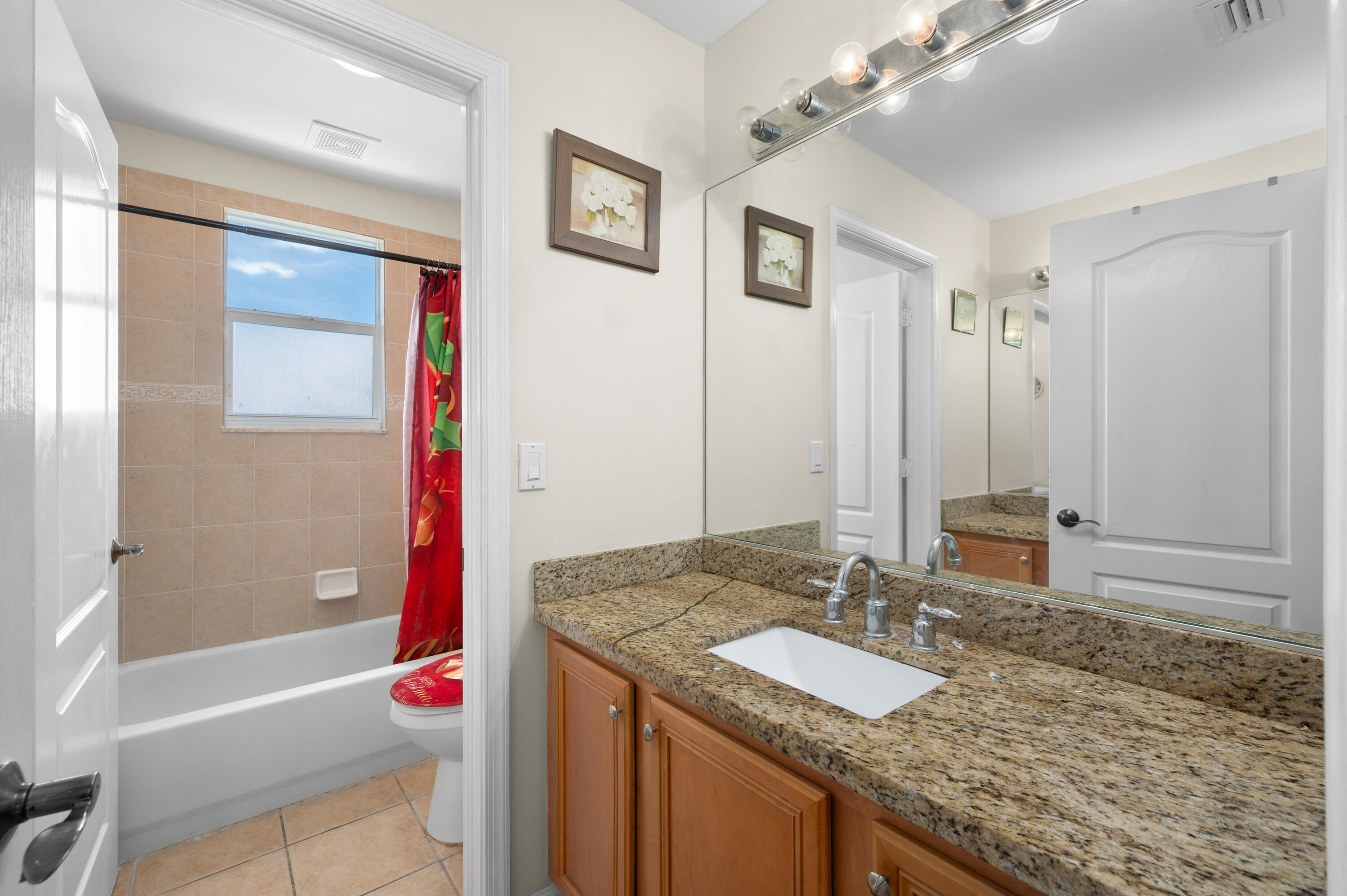 311 Berenger Walk Royal Palm Beach, FL 33414 - Photo 21 of 34 a bathroom with a granite countertop tub sink and mirror