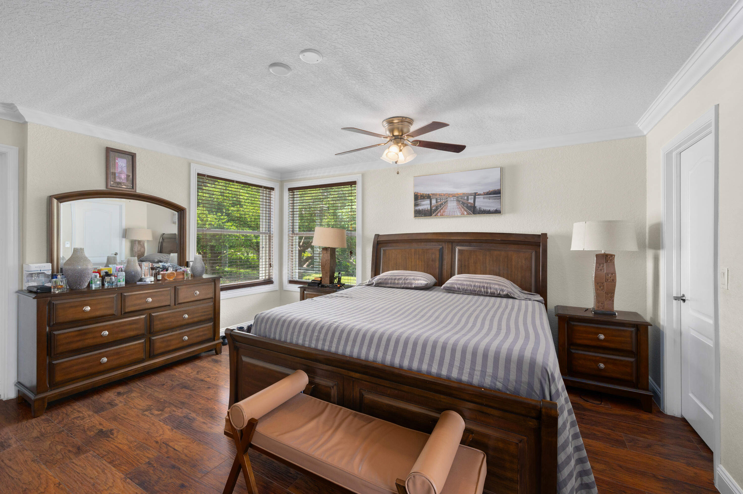 311 Berenger Walk Royal Palm Beach, FL 33414 - Photo 23 of 34 a bedroom with a bed and wooden floor