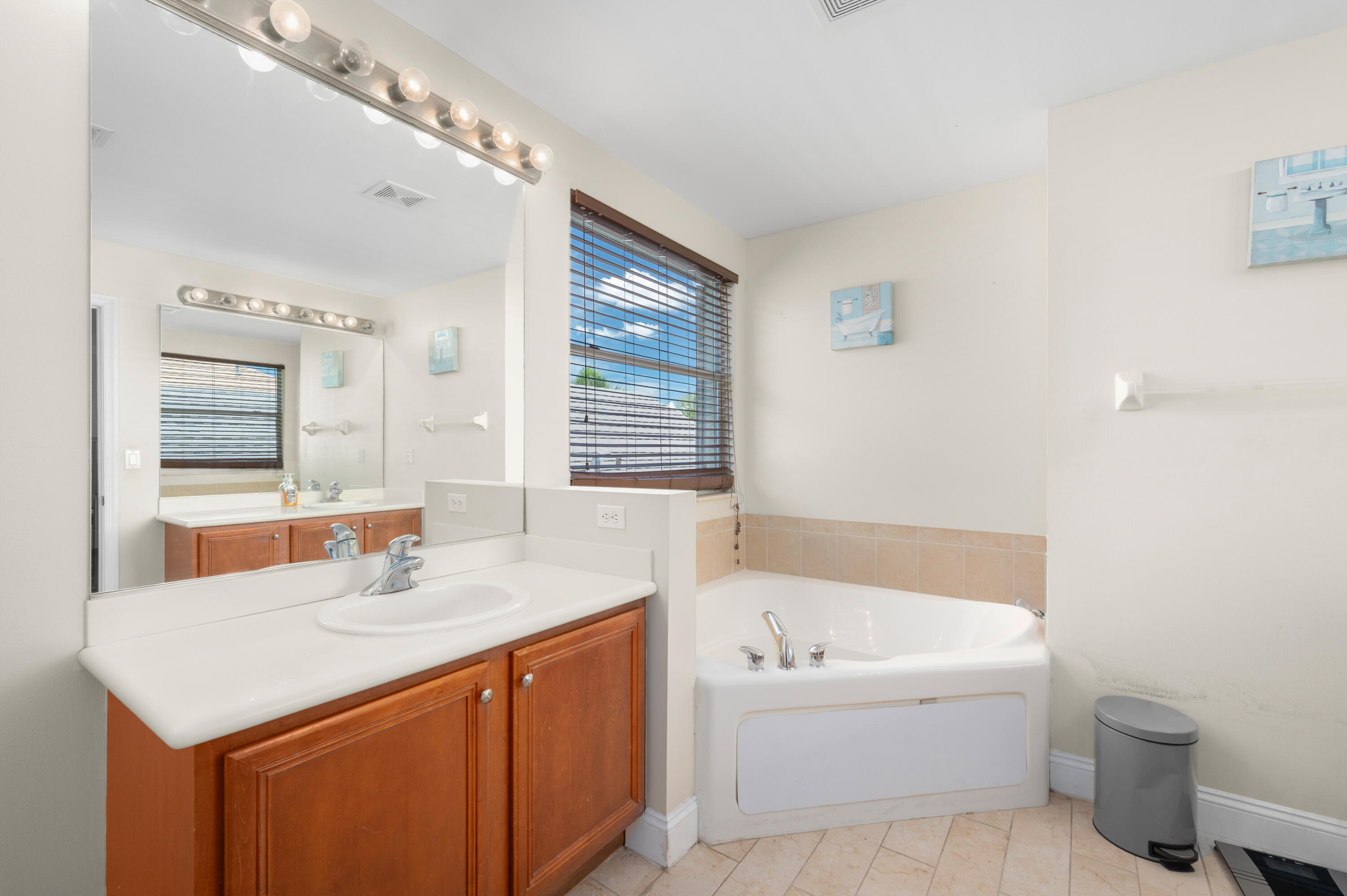 311 Berenger Walk Royal Palm Beach, FL 33414 - Photo 26 of 34 a bathroom with a sink double vanity mirror and a bathtub