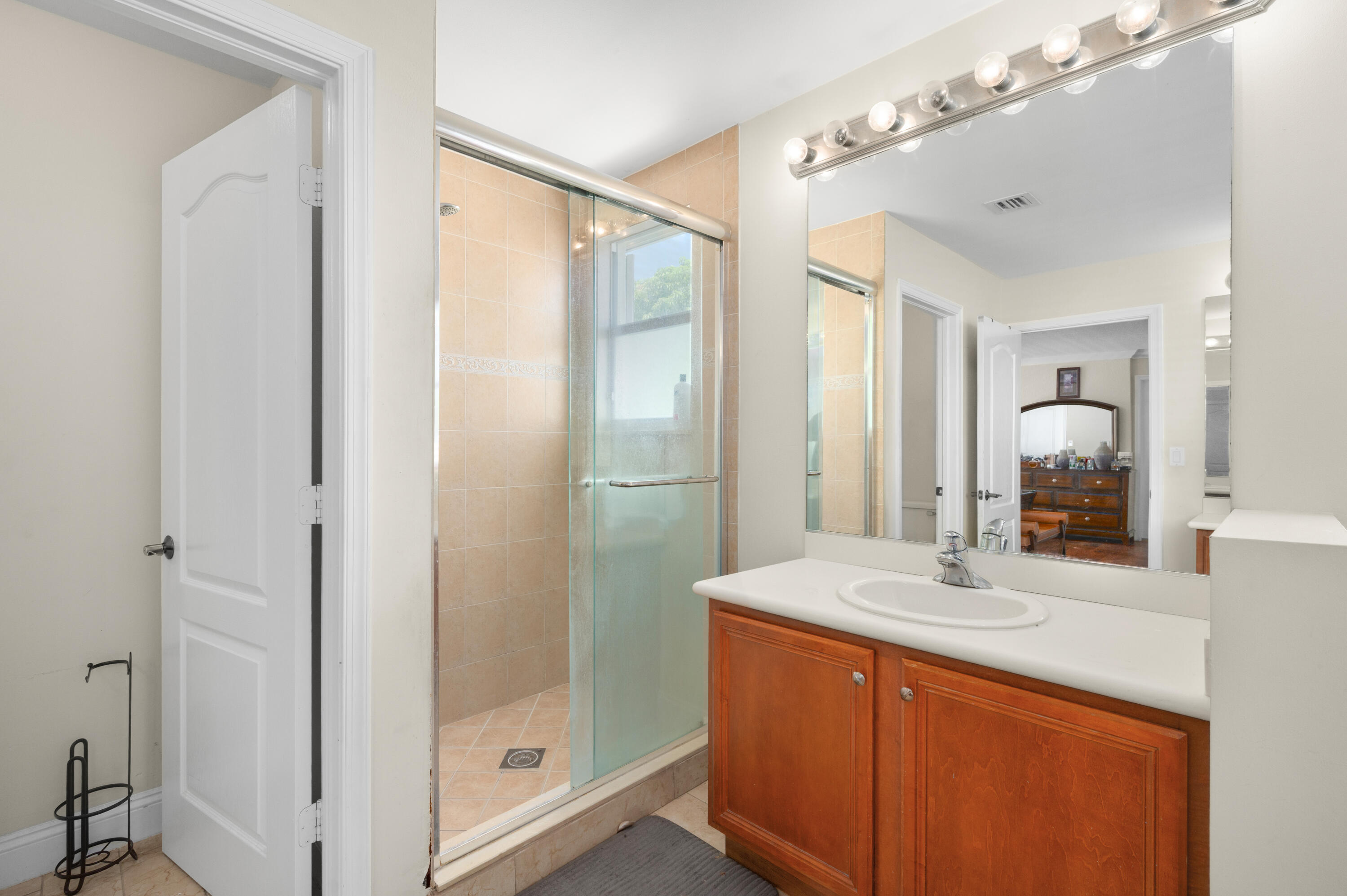 311 Berenger Walk Royal Palm Beach, FL 33414 - Photo 27 of 34 a bathroom with a shower sink and mirror